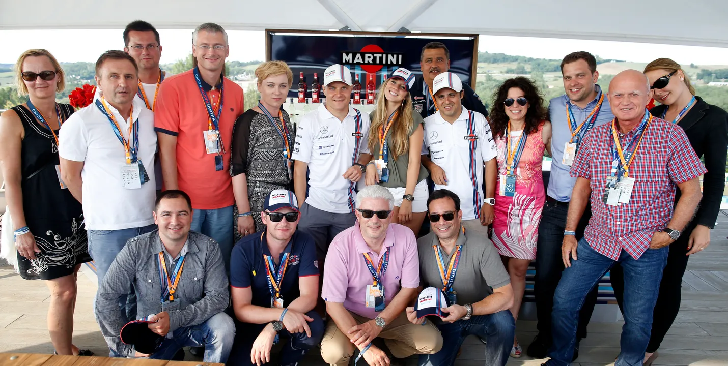 GUESTS ENJOYING MARTINI COCKTAILS AT THE WILLIAMS MARTINI RACING MOTORHOME IN BUDAPEST